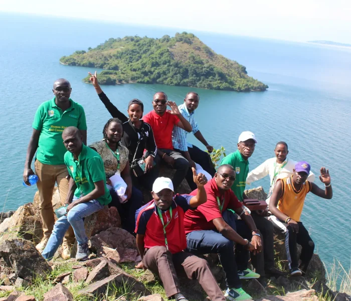 Faculty in Field on island hands raised - women - KitabiIMG_1418